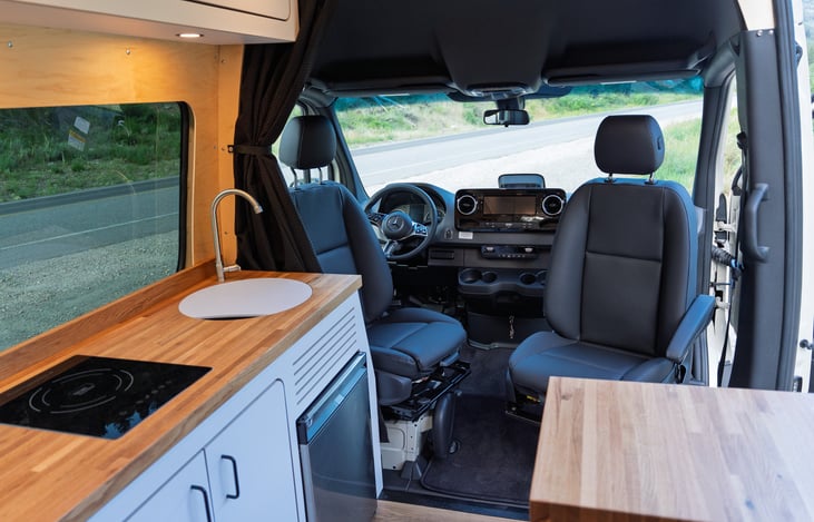 front seats swivel. Van has a total of 6 seatbelts. NOTE: SLEEPS 2!