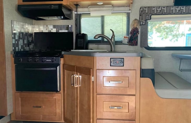 Kitchen is well stocked with pots and pans, as well as disposable plates, silverware, cups.