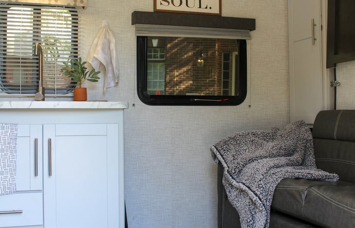 View up the steps, to the right you will see the sofa/queen Murphy bed discreetly  tucked in. This allows for space to move around, watch T.V and relax!
