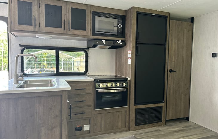 Kitchen Includes all silverware, Plates, Bowls, and cooking utensils, pots and pans, coffee pot, toaster, and small Airfryer.