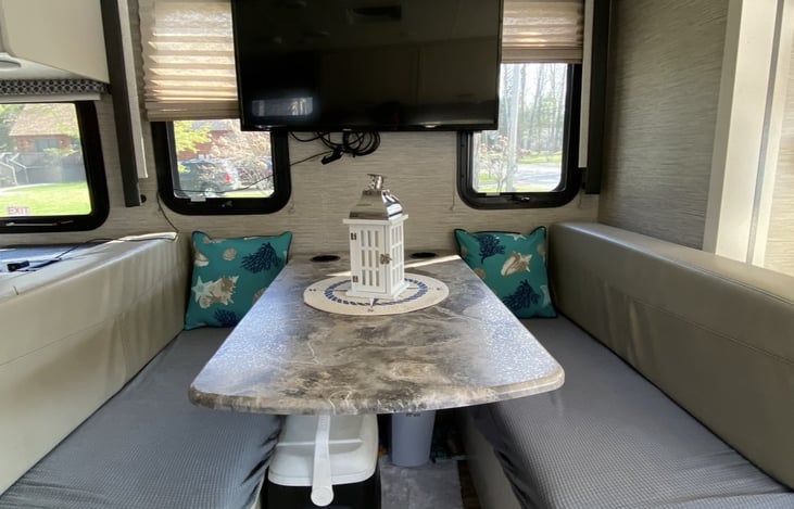 Dinette w seatbelts for travel, seating for 4 and converts to a sleep area for 1-2