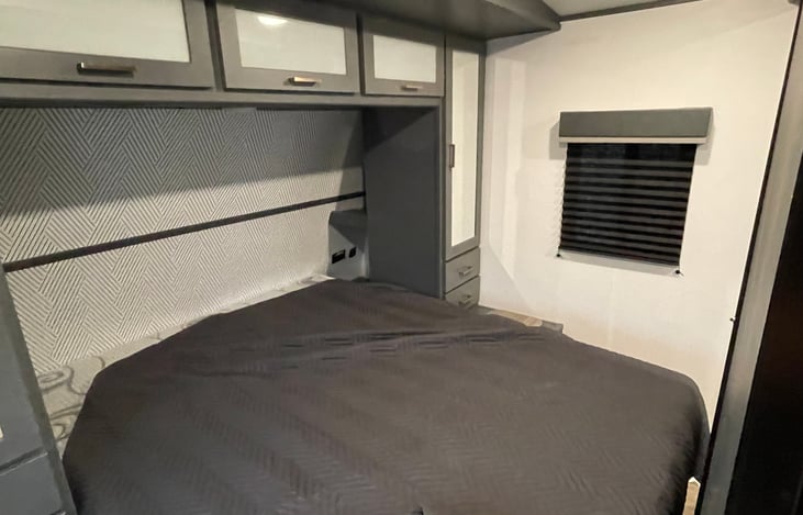 Queen bed with 2 separate hanging closets, 1 drawer on each side. 3 cabinets above for storage. USB and plugs on each side. Private room. Storage under bed. Linens and pillows included. TV hookup
