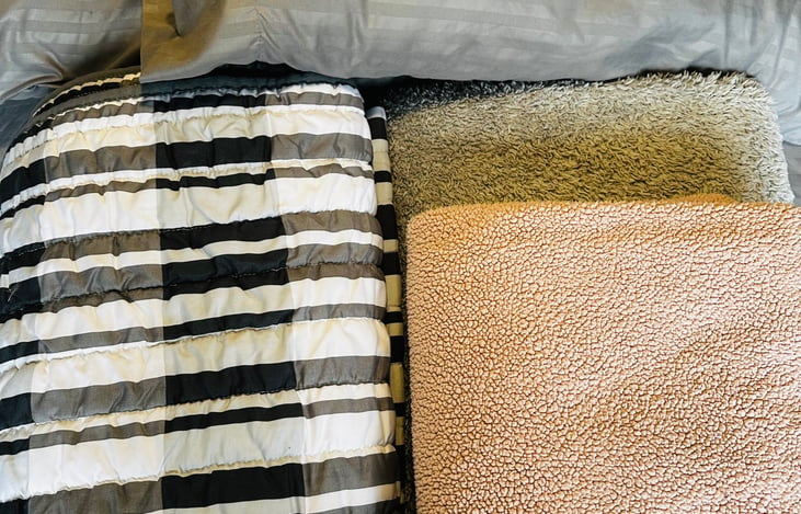 Linens for the Murphy bed- one sheet set, two pillows, one large blanket, one coverlet, and one throw blanket (patterns in blankets may vary)