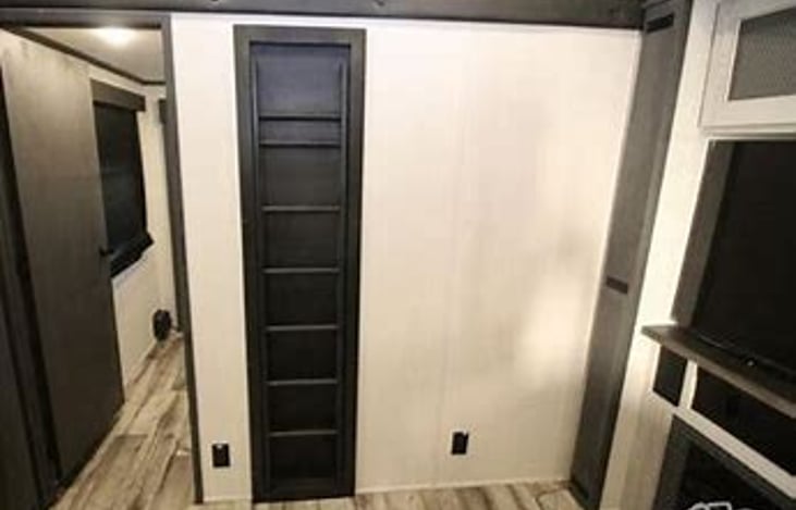 Ladder to loft and back door to bunk room that has its own exit.