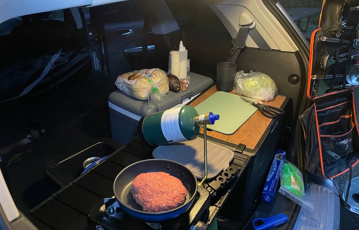 Getting setup for supper, the stove is positioned to avoid getting fumes from cooking in the car.  Opening the back doors is helpful as well.