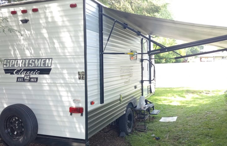 14' Awning that provides extensive shading and coverage over a picnic table or outdoor sitting area