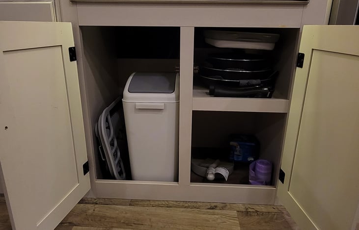 Pots and pans with removable handle stored under sink.  Trash can and bags included. Also, a collapsible dish rack to dry those sparkling clean dishes!