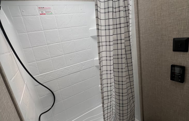 Stand up shower with on-demand hot water system, toilet