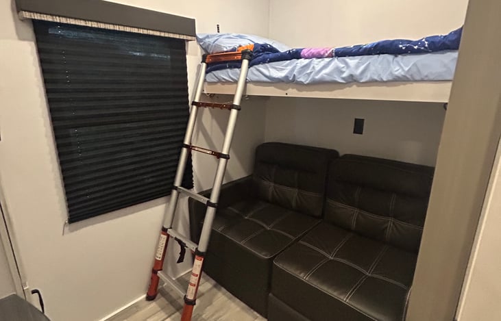 Twin bunk with a fold out full sofa bed below.