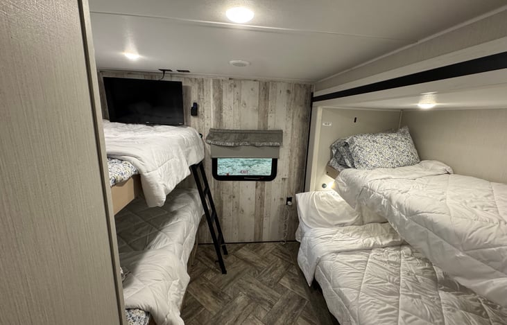 Bunk beds. 3 twin sized beds & 1 small double. TV for entertainment.