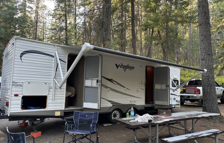 Awning fully extended with both doors open. Front door enters living room/kitchen. Back door enters bedroom.