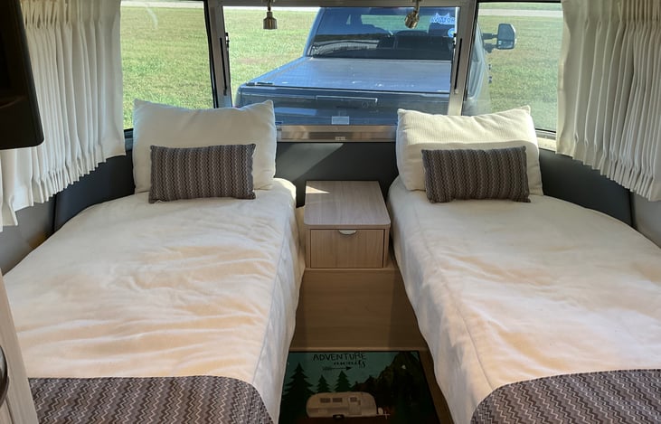 Twin beds with two hanging closets and storage under the beds.