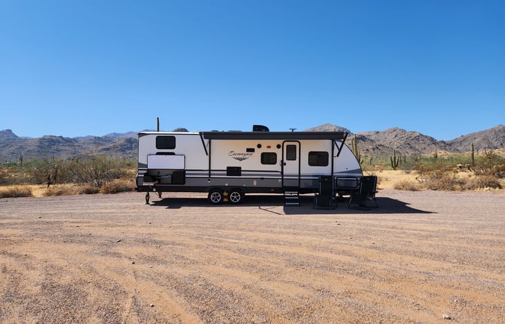 Camp side with Outdoor Kitchen and 16' awning extended. 2 reclining folding chairs for your comfort.