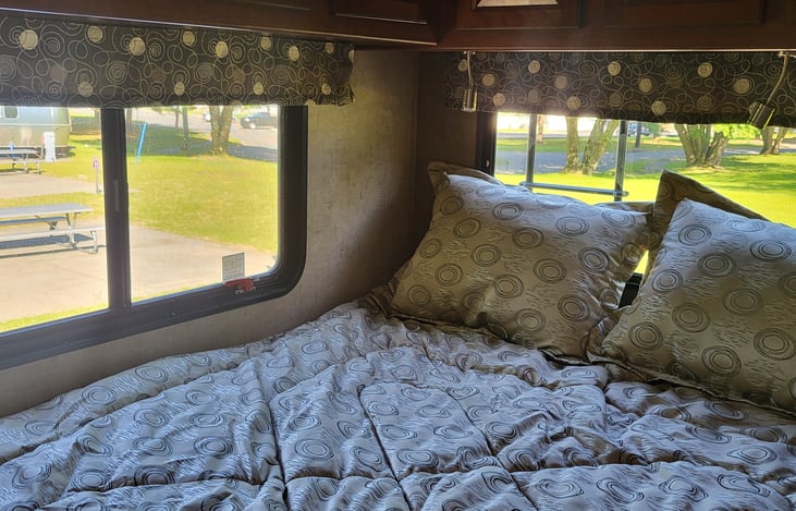 Queen size bed in rear with 24inch television