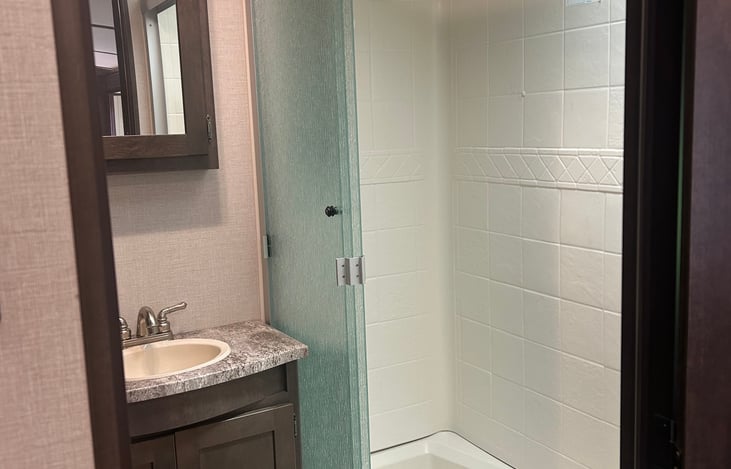 Single vanity and walk in shower.