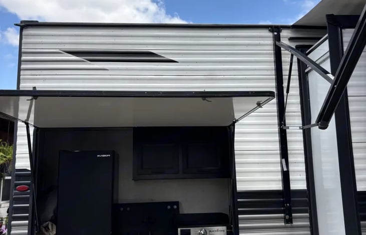 Outdoor Kitchen (Includes a mini fridge, sink and Blackstone grill)