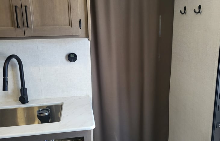 Privacy curtain separating the private bedroom from kitchen