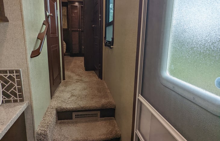 Hallway to bathroom on left and Master bedroom ahead.