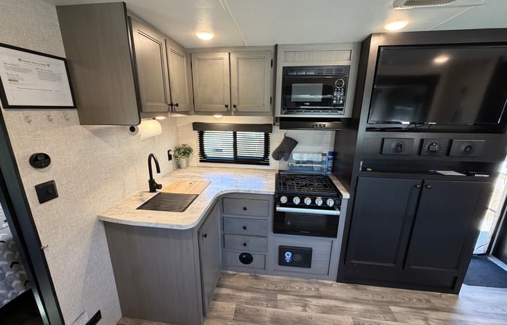 Fully stocked kitchen (utensils, basic seasonings, plaster and paper dishes and cups, cast iron pans) with stove, oven, microwave and large basin sink. Big screen TV and JBL Bluetooth speakers.