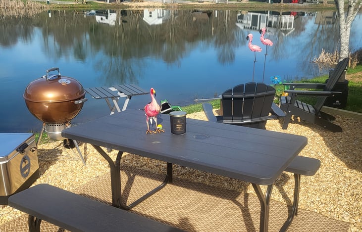 The property includes a lakeside view, picnic table, grill and fire pit.