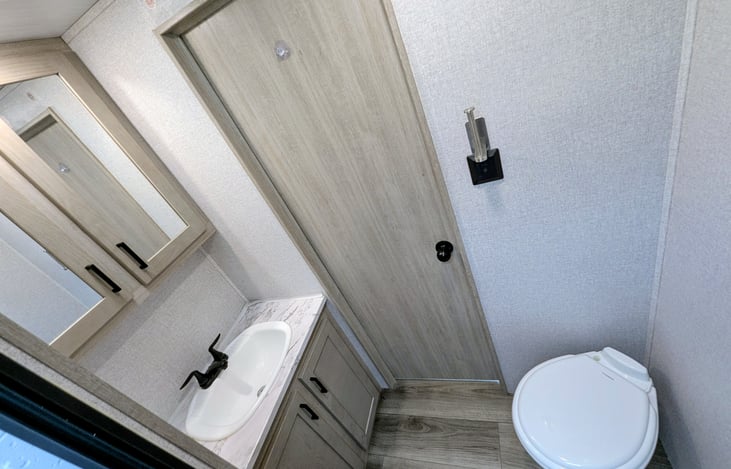 Spacious bathroom with shower and toilet.