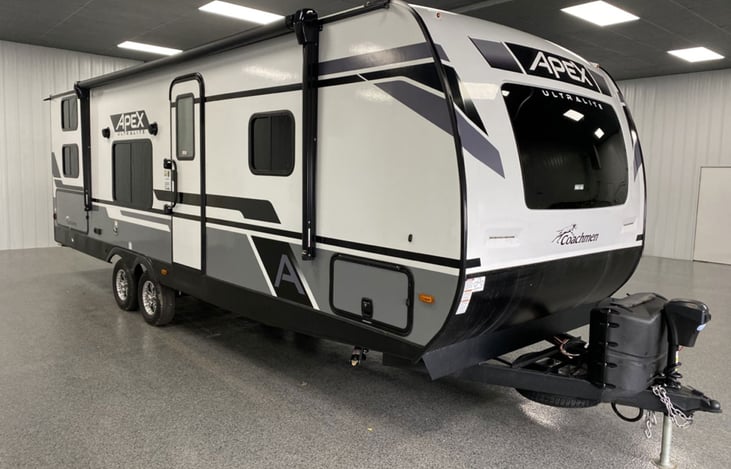 Front door-side quarter view of rig