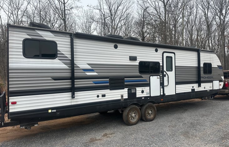 Camper with Awning and Outdoor LED Lights.