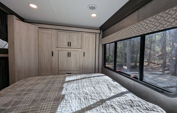 Cozy private bedroom with Queen bed and ample storage at the rear.