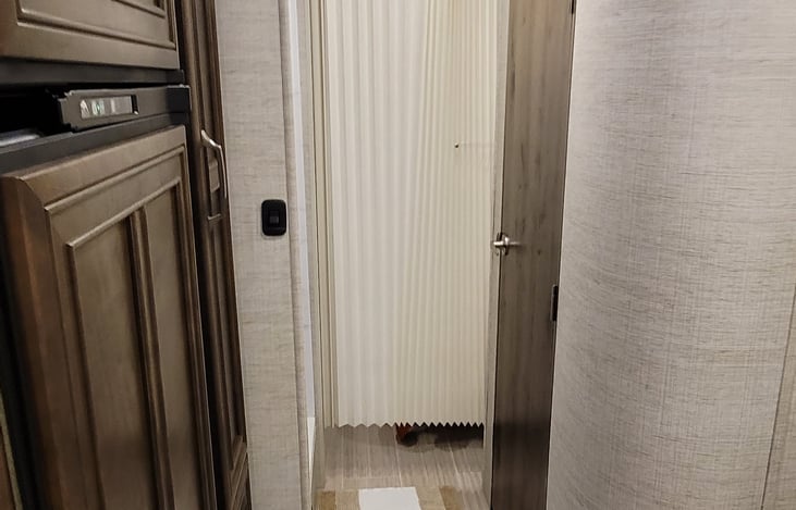 Folding door in bedroom blocking off only bedroom leaving the bathroom and shower still accessible.