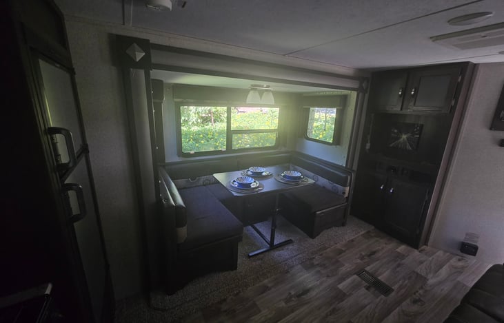 Spacious dinette in slide-out that converts to a full-size bed.