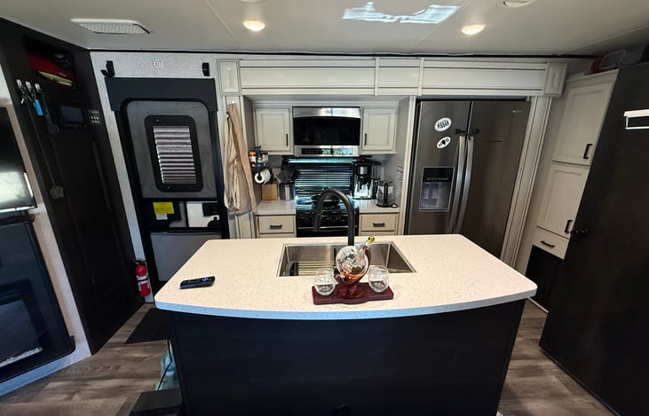 Three burner stove, microwave, dishes for 4 people and silverware plus cups.