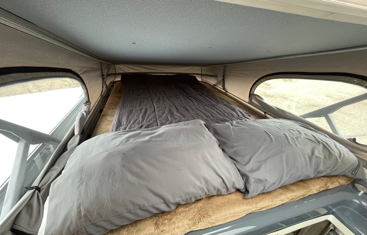 Pop top sleeping area. Size of a full bed. Fits two adults comfortably.