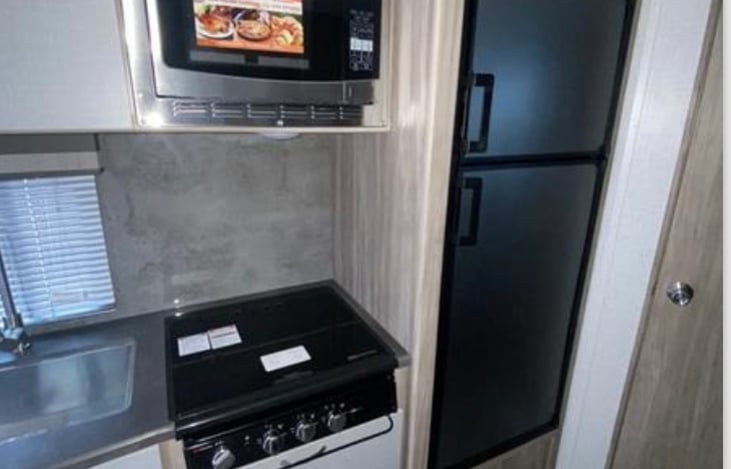 Good sized fridge/freezer, 3 range gas stove, microwave that also bakes.