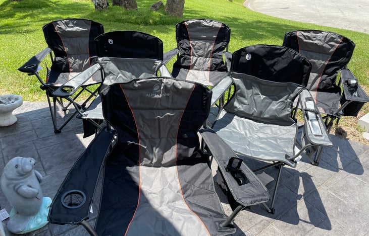 A option RVs come with a big man capacity chair & regular chair, cost of $10 per chair per stay, Big man capacity chair holds up to 400 lbs and  a drink holder on 1 side thermo pocket other