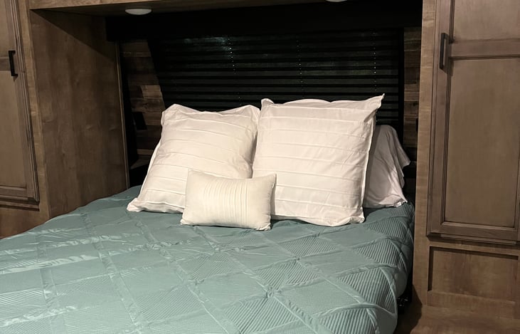 Main bedroom with short queen size bed.  TV in this room.  Sheets, comforter and pillows provided.