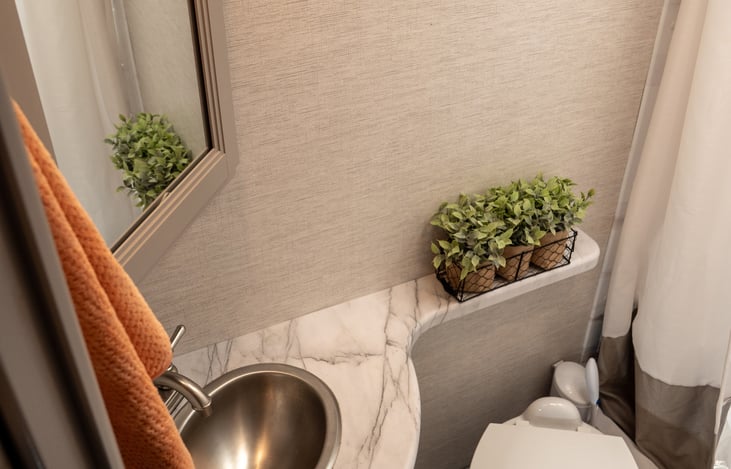 corner vanity with extra counter space, under sink storage and mirrored medicine cabinet
