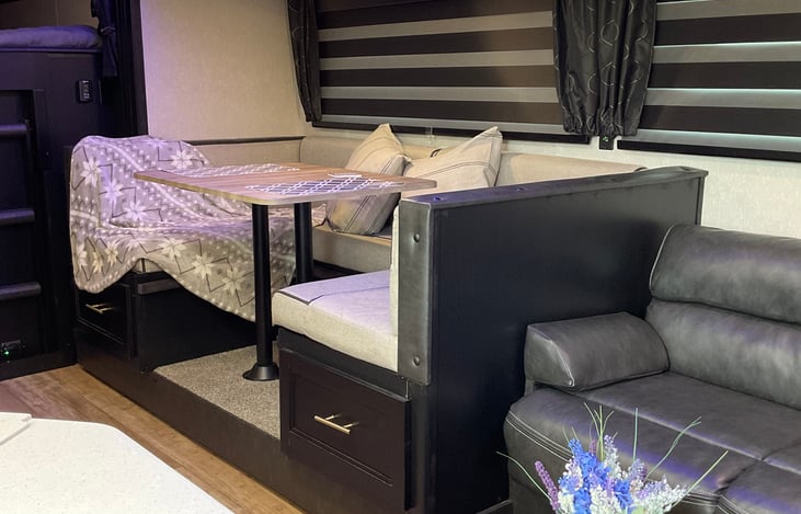 Dinette area with zebra shades pulled down.