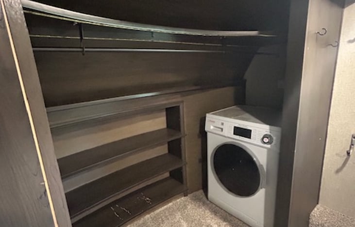 Queen sized bed; main bedroom with closet, small washer/dryer combo unit and locking bedroom door.