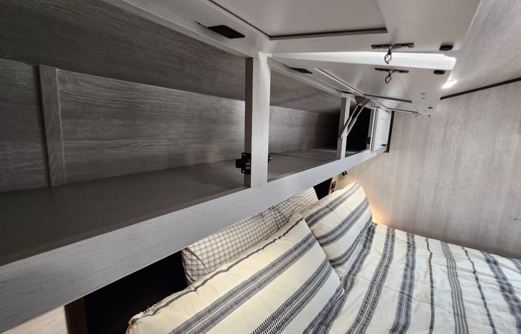 Private bedroom storage area above the bed.