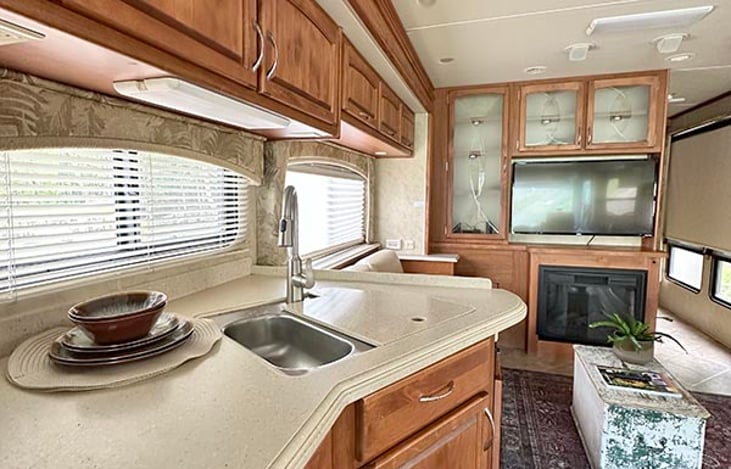 kitchen with propane stove and oven, microwave and refrigerator