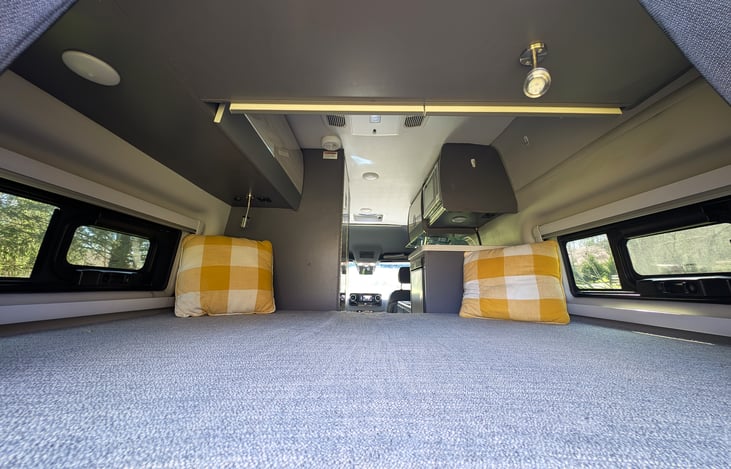 Comfortable bed in the back with storage cubbies all around.