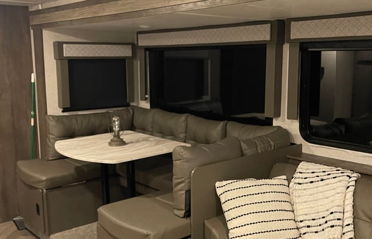 There are two easily accessible  storage compartments  under where you sit at. Directly behind the small window is a stand up pantry.