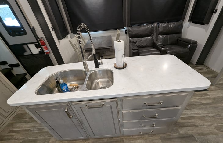 Chef’s dream galley! Features a massive 18 cu. ft. fridge, residential microwave, and 3-burner stove. Enjoy the solid-surface islands, deep sink, and pantry—perfect for feeding the whole crew.