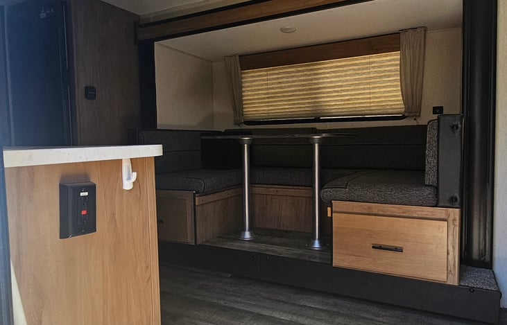 Dinette Converts into a sleeper for the 5th guest. Bottom drawers are empty and ready for your dry storage items or personal items you bring. Extra bedding is provided for your convenience.