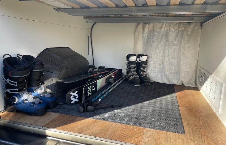 Under cabinet storage for skis