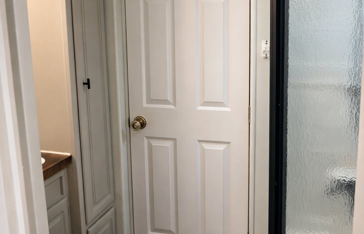 Clean, private bathroom with modern finishes and thoughtful storage.
