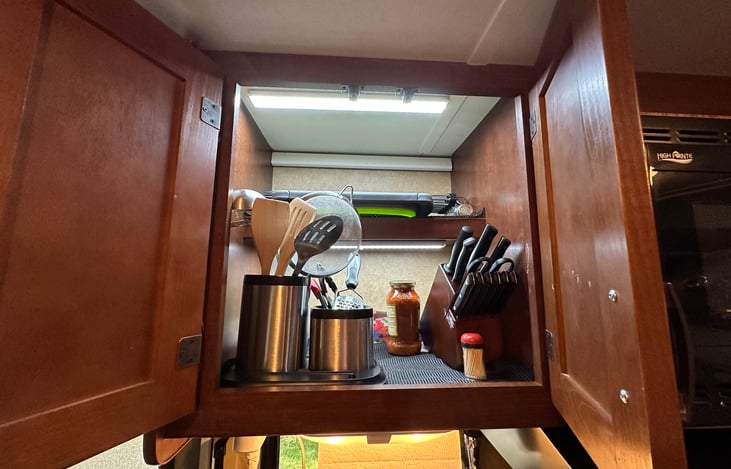 Over the kitchen sink cabinet with kitchen utensils