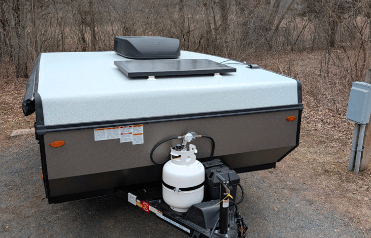When the camper is all closed up, it is 13.7 feet. 
On the top of the camper, you can see the AC unit in addition to the 100-w solar panel.
