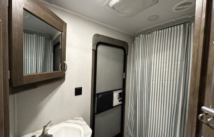 Bathroom with separate outdoor entry plus vent insulator to help stop heat transfer, keeping your RV cooler in summer and warmer in winter.  (actual image)