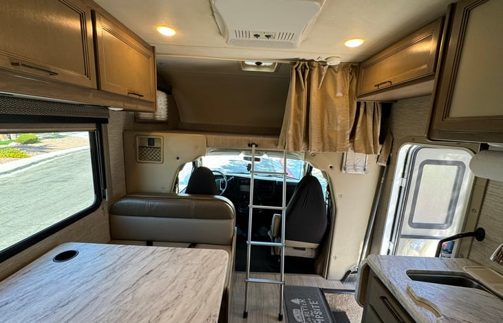 The upper bunk bed can sleep up to two adults, a privacy curtain, and a bunk ladder.  Bedding can be added as an add-on, see convenience kit add-on.